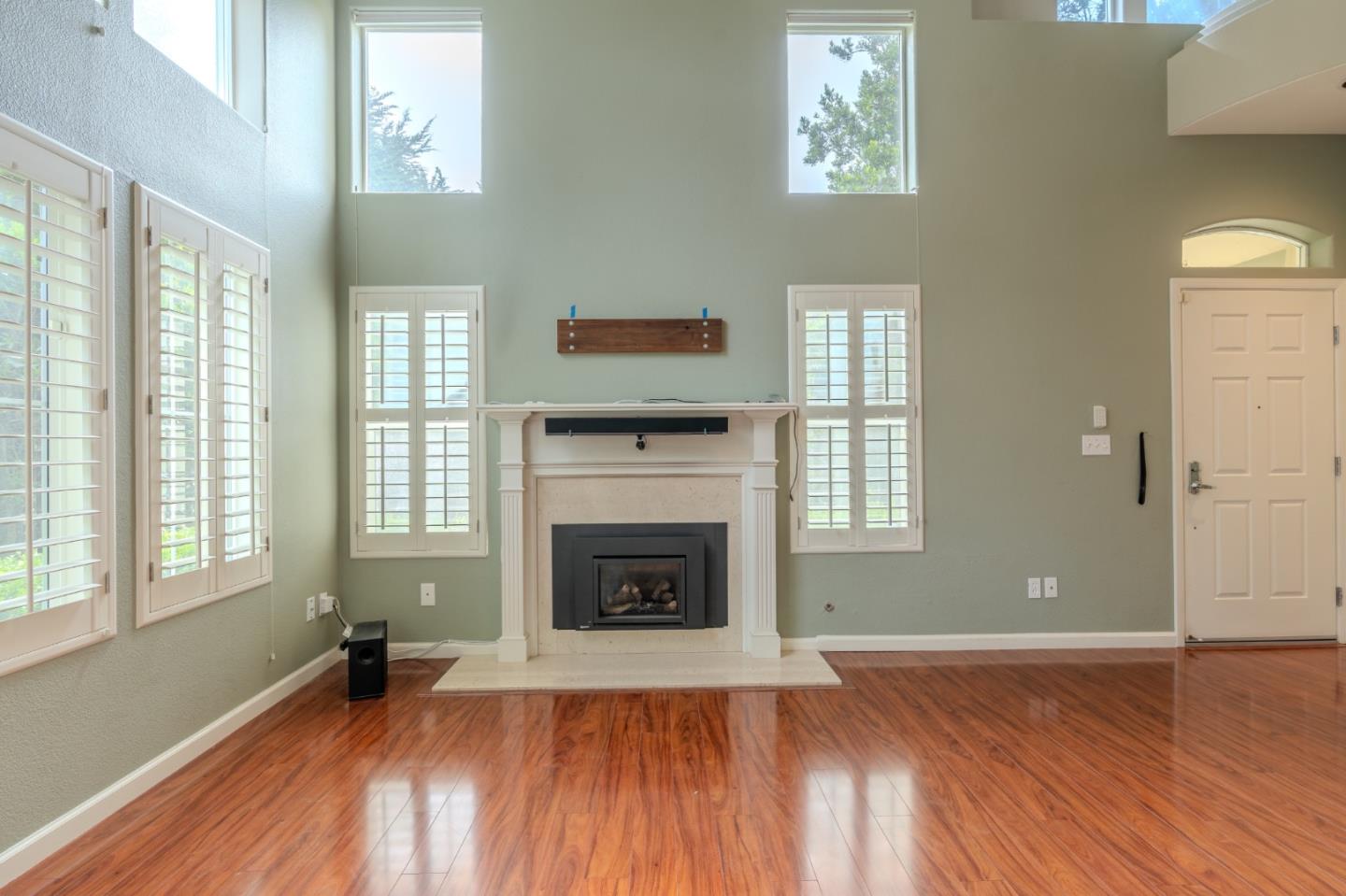 132 Patrick Way Half Moon Bay, CA 94019 - Photo 4 of 29 wooden floor fireplace and windows in an empty room