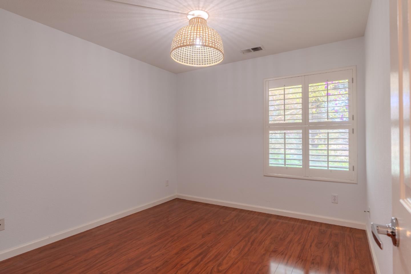132 Patrick Way Half Moon Bay, CA 94019 - Photo 7 of 29 an empty room with wooden floor and windows