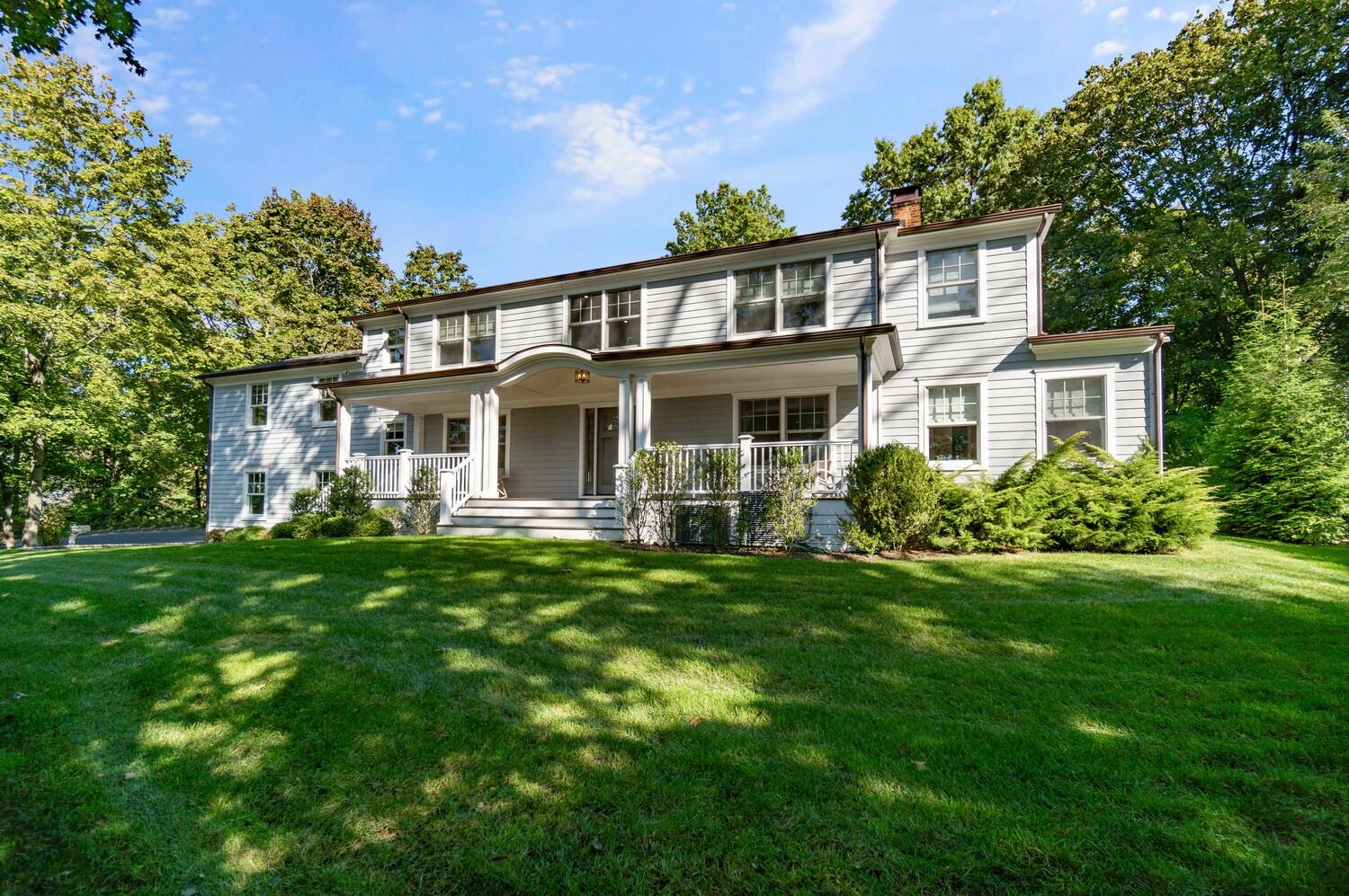 2 Hollow Tree Ridge Road Darien, CT 06820 - Photo 1 of 40 a front view of a house with a garden