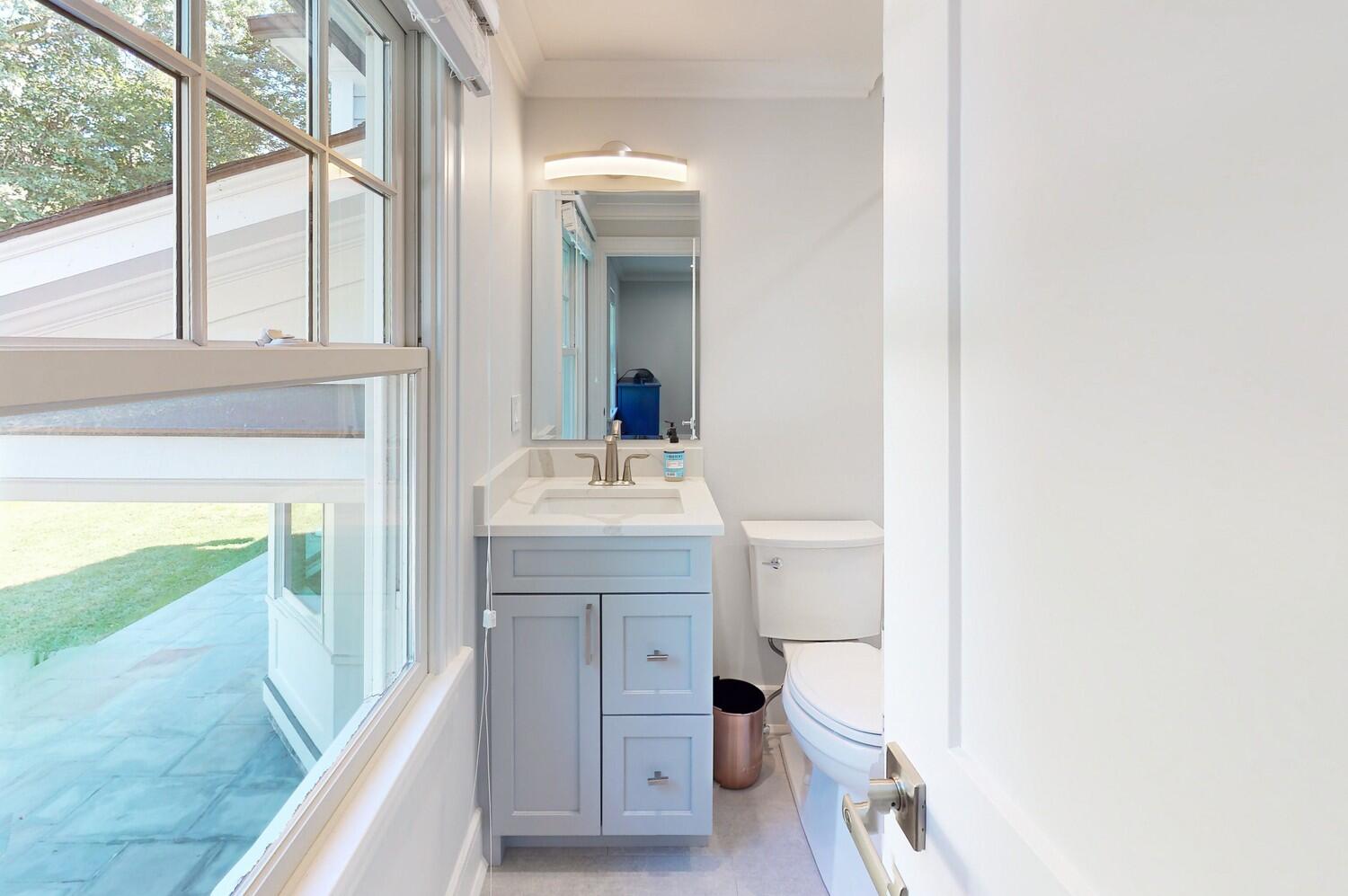2 Hollow Tree Ridge Road Darien, CT 06820 - Photo 34 of 40 a bathroom with a sink a toilet and a mirror