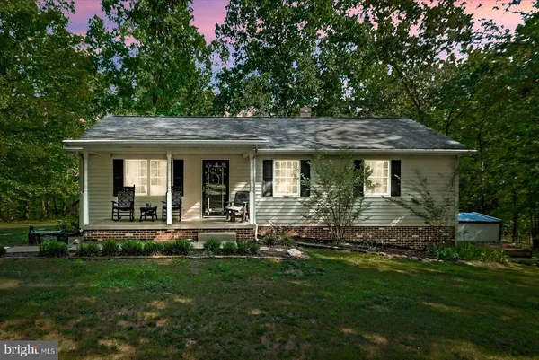 a front view of house with a garden