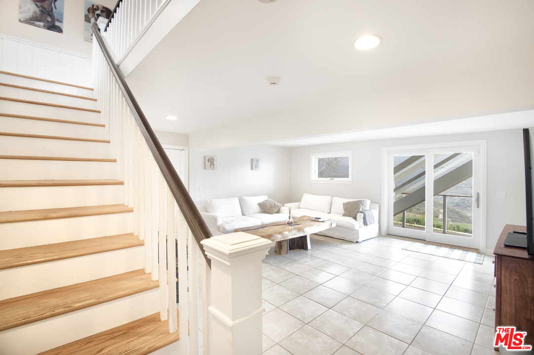 26258 Fairside Road Malibu, CA 90265 - Photo 13 of 46 a living room with furniture and a large window