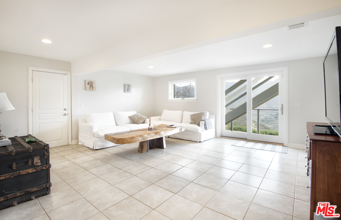 26258 Fairside Road Malibu, CA 90265 - Photo 15 of 46 a bed room with a bed and a large window