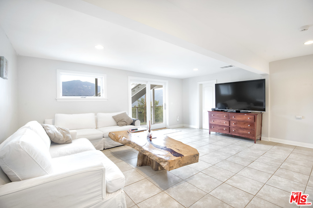 26258 Fairside Road Malibu, CA 90265 - Photo 16 of 46 a living room with furniture and a flat screen tv