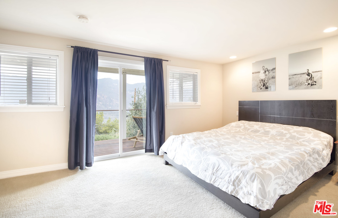 26258 Fairside Road Malibu, CA 90265 - Photo 17 of 46 a bedroom with a large bed and a large window