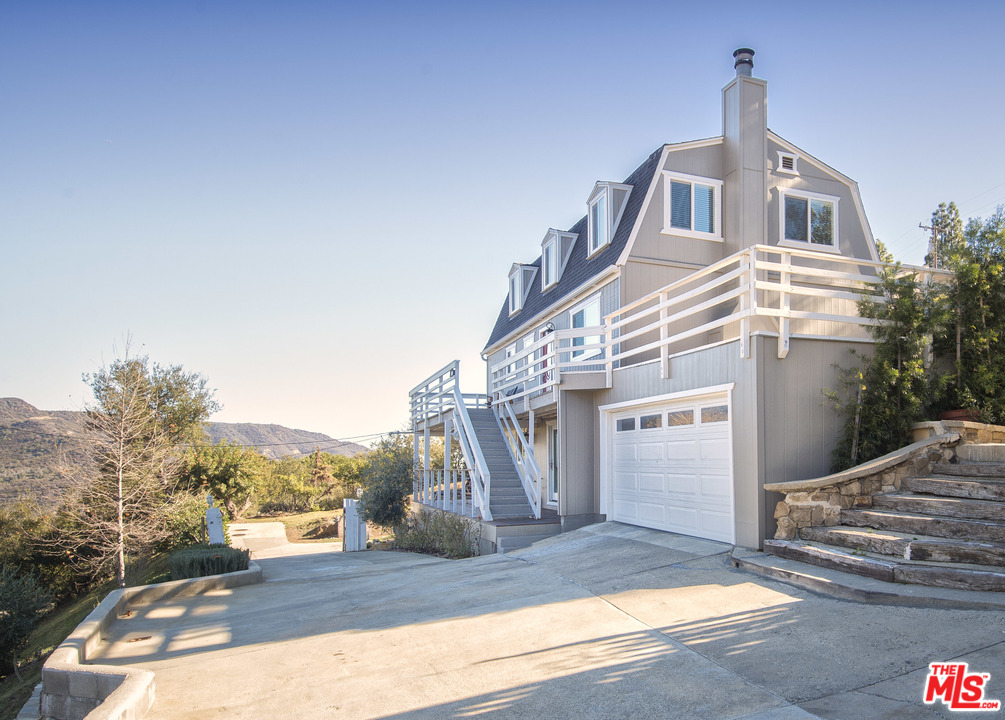 26258 Fairside Road Malibu, CA 90265 - Photo 3 of 46 a front view of a house with a yard