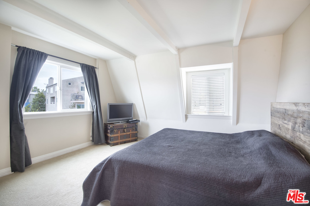 26258 Fairside Road Malibu, CA 90265 - Photo 21 of 46 a bedroom with a bed flat screen tv and a large window