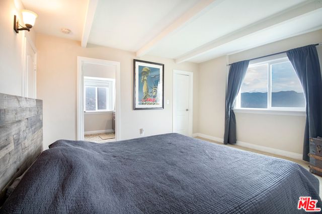 a bathroom with a granite countertop sink a mirror and a toilet
