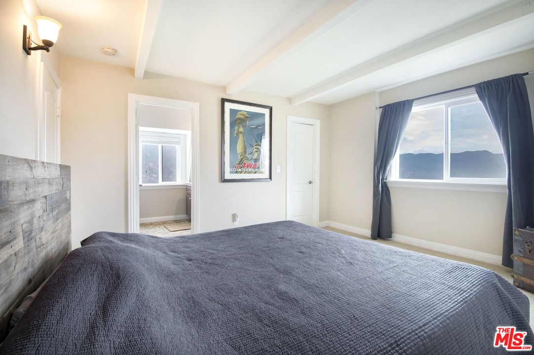 26258 Fairside Road Malibu, CA 90265 - Photo 22 of 46 a bedroom with a bed and a window