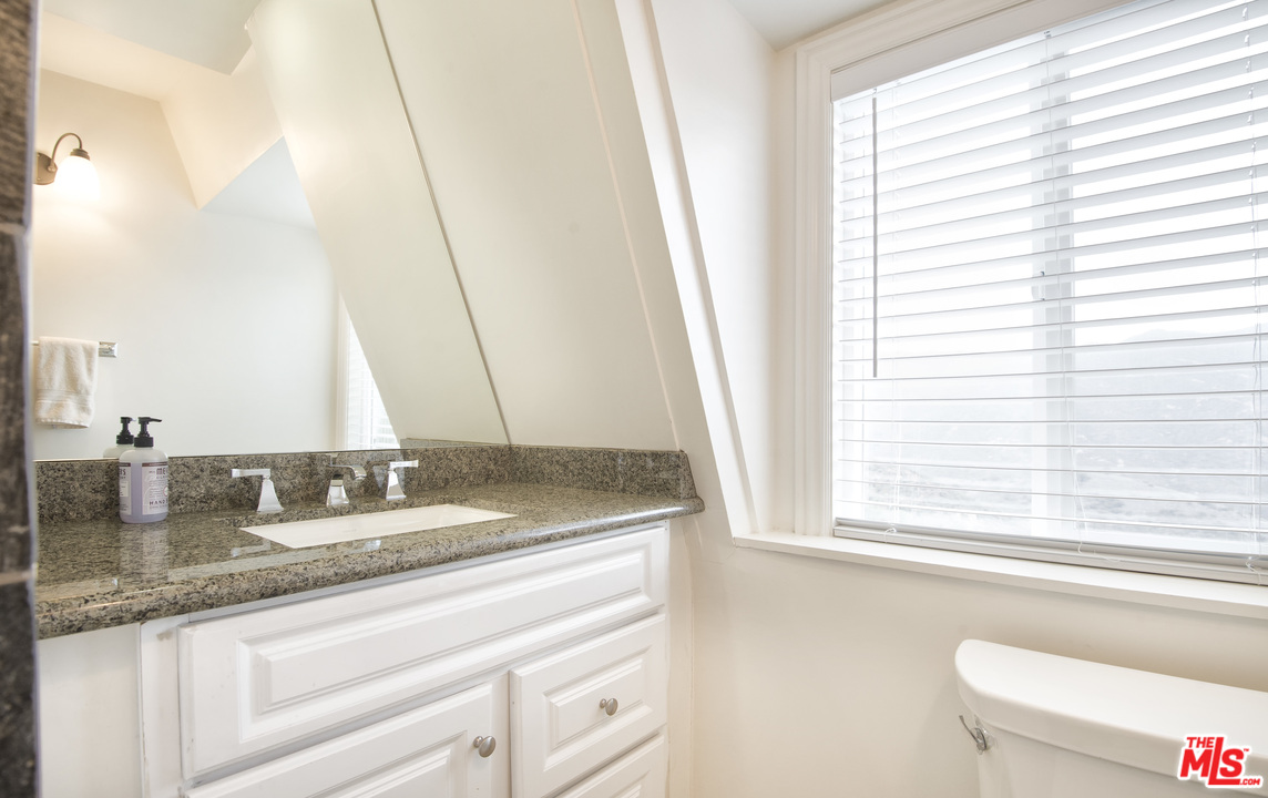 26258 Fairside Road Malibu, CA 90265 - Photo 25 of 46 a bathroom with a granite countertop sink and a window
