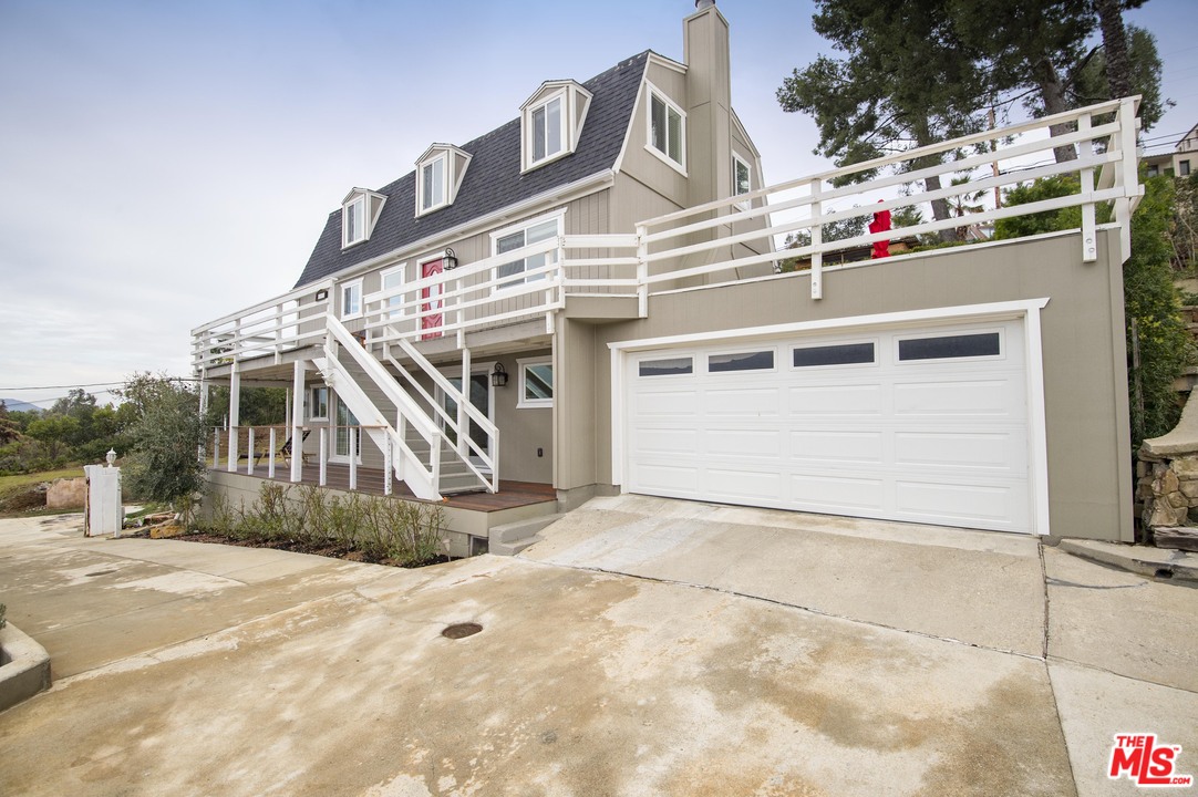 26258 Fairside Road Malibu, CA 90265 - Photo 4 of 46 a front view of a house with a garage