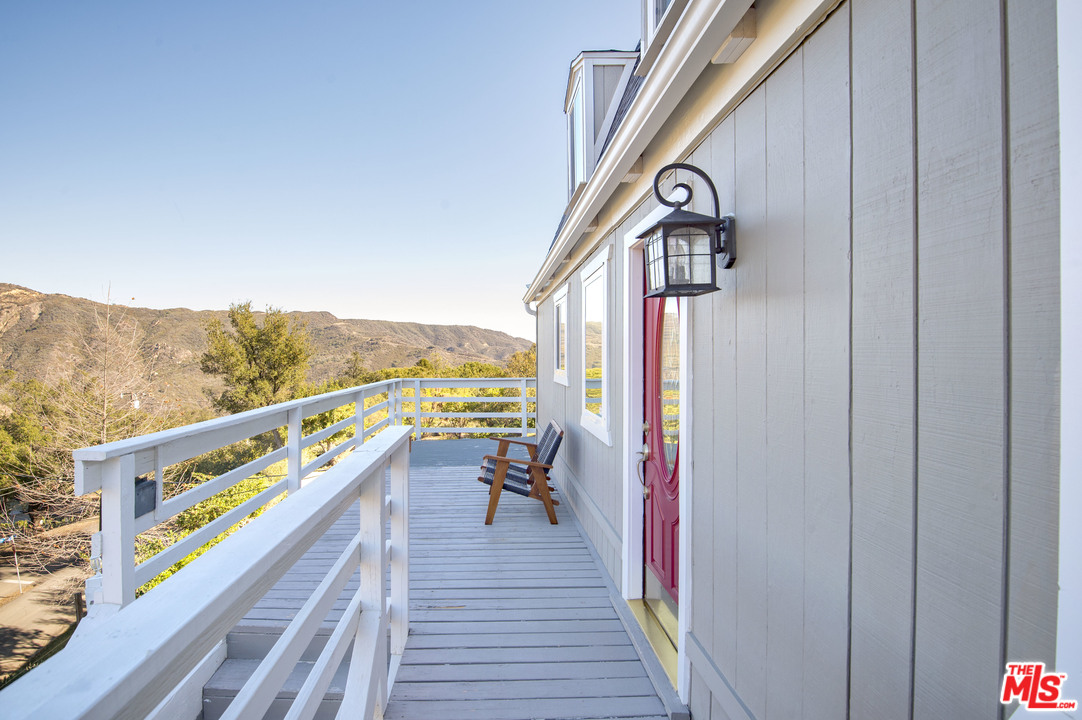 26258 Fairside Road Malibu, CA 90265 - Photo 32 of 46 a view of a balcony with furniture and wooden floor