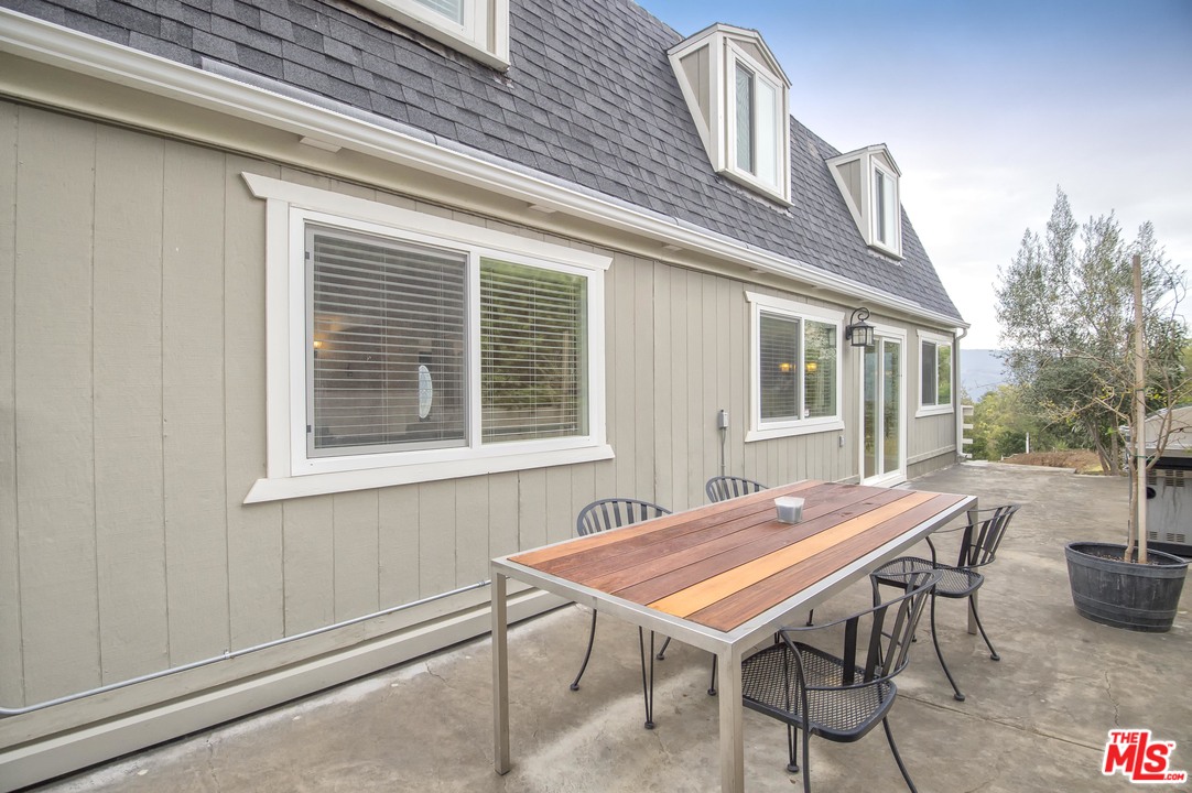 26258 Fairside Road Malibu, CA 90265 - Photo 34 of 46 a table and chairs in front of a house
