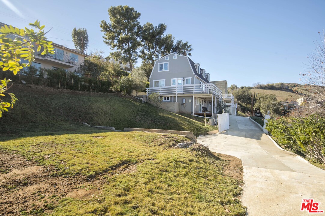 26258 Fairside Road Malibu, CA 90265 - Photo 41 of 46 a front view of a house with a yard
