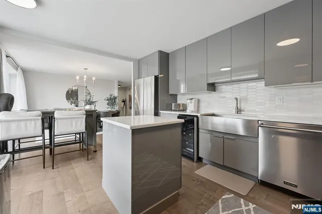 a living room with a floor to ceiling window and a glass door