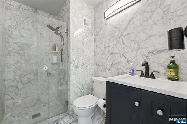 a living room with furniture a lamp and a dining table with kitchen view