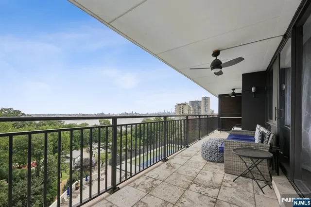a view of building with swimming pool and sitting area