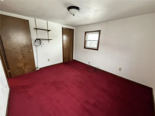 a view of empty room with a fireplace