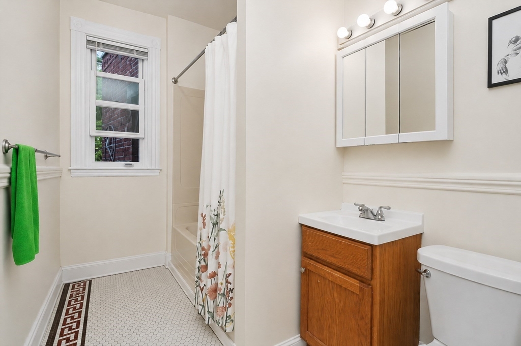8 Colliston Road Boston, MA 02135 - Photo 10 of 40 a bathroom with a sink a toilet and a shower