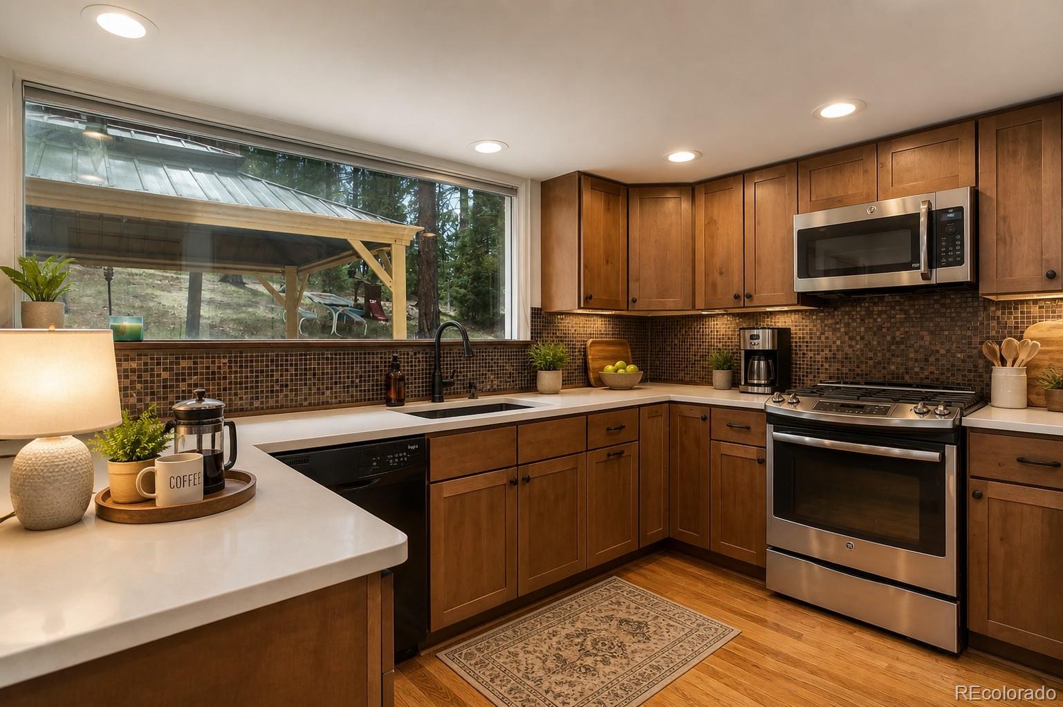 8795 Rudd Road Evergreen, CO 80439 - Photo 3 of 37 a kitchen with sink cabinets and microwave