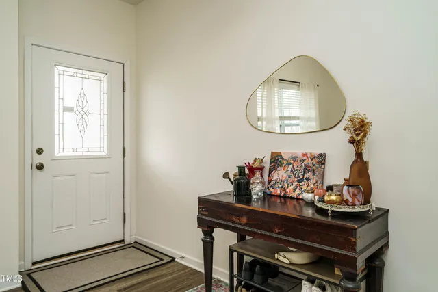 a room with painting on the wall and a window