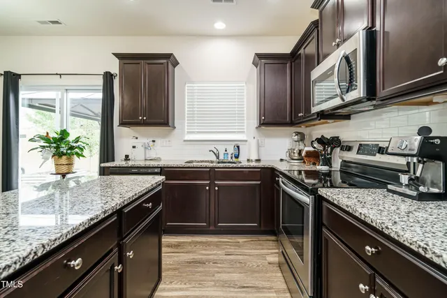 a kitchen with granite countertop stainless steel appliances and sink