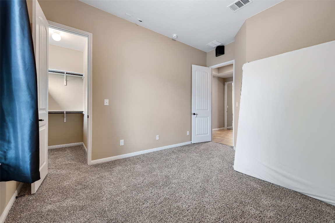 2000 Manada Trail Leander, TX 78641 - Photo 30 of 36 Well-lit sleeping quarters with plush carpeting offers comfort and personal storage.
