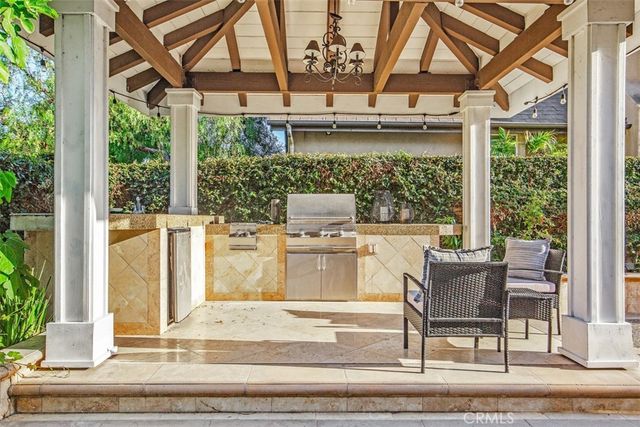 a backyard of a house with table and chairs potted plants