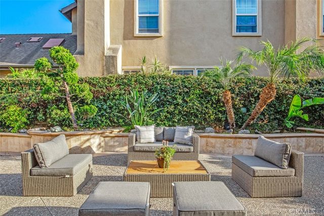 a view of patio with couches and a potted plant on a table