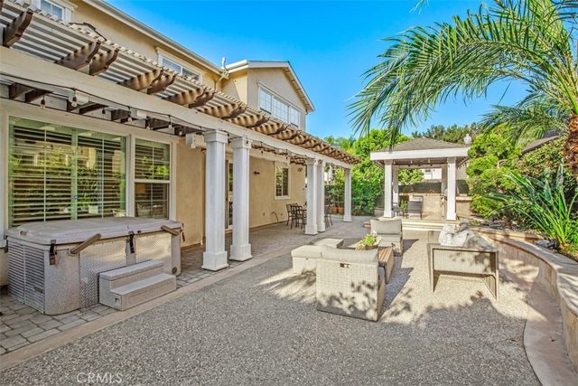 a view of an outdoor dining space with a table and chairs