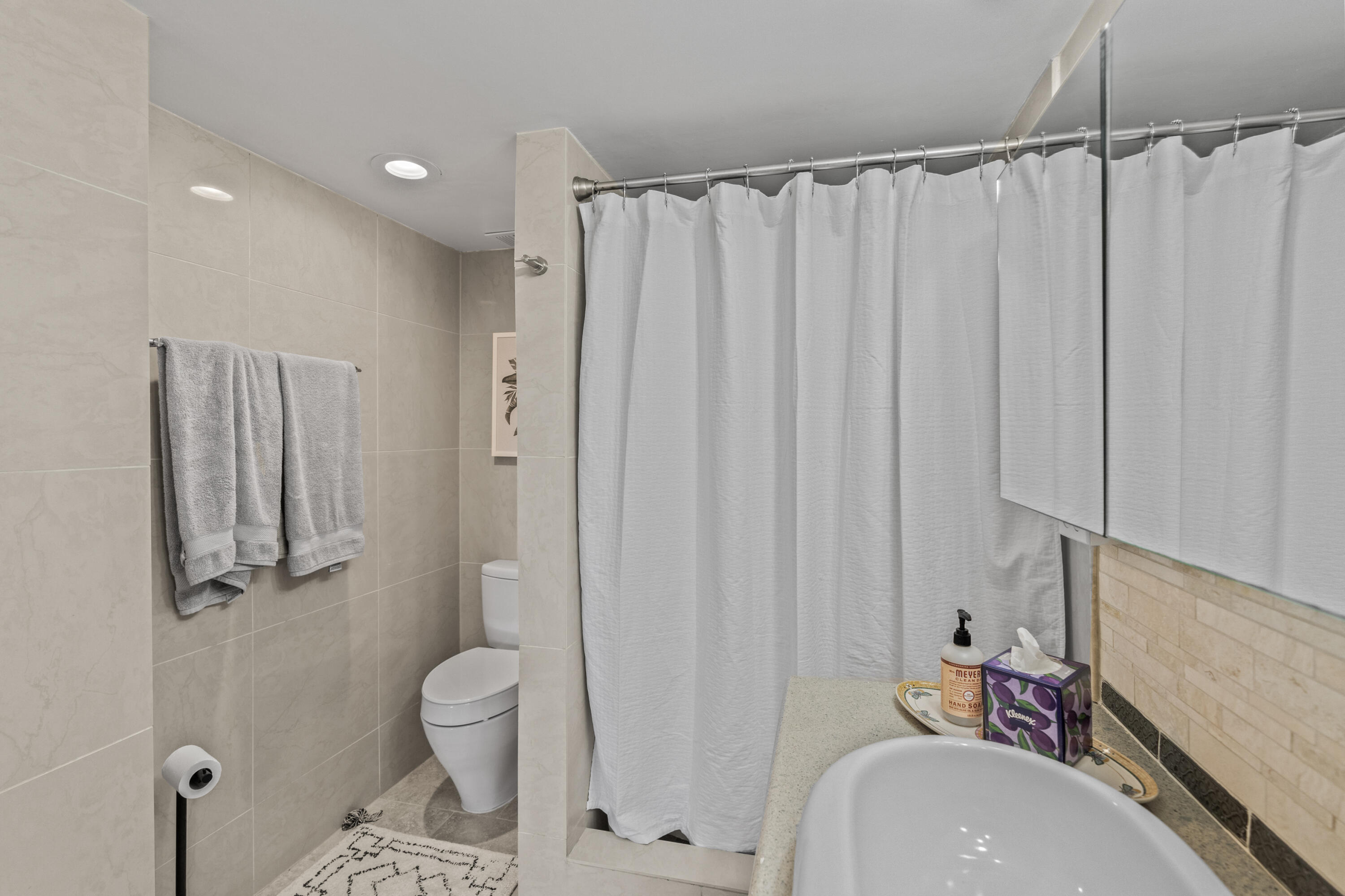 750 Northeast Spanish River Boulevard, Unit 2040 Boca Raton, FL 33431 - Photo 12 of 40 a bathroom with a sink toilet and shower