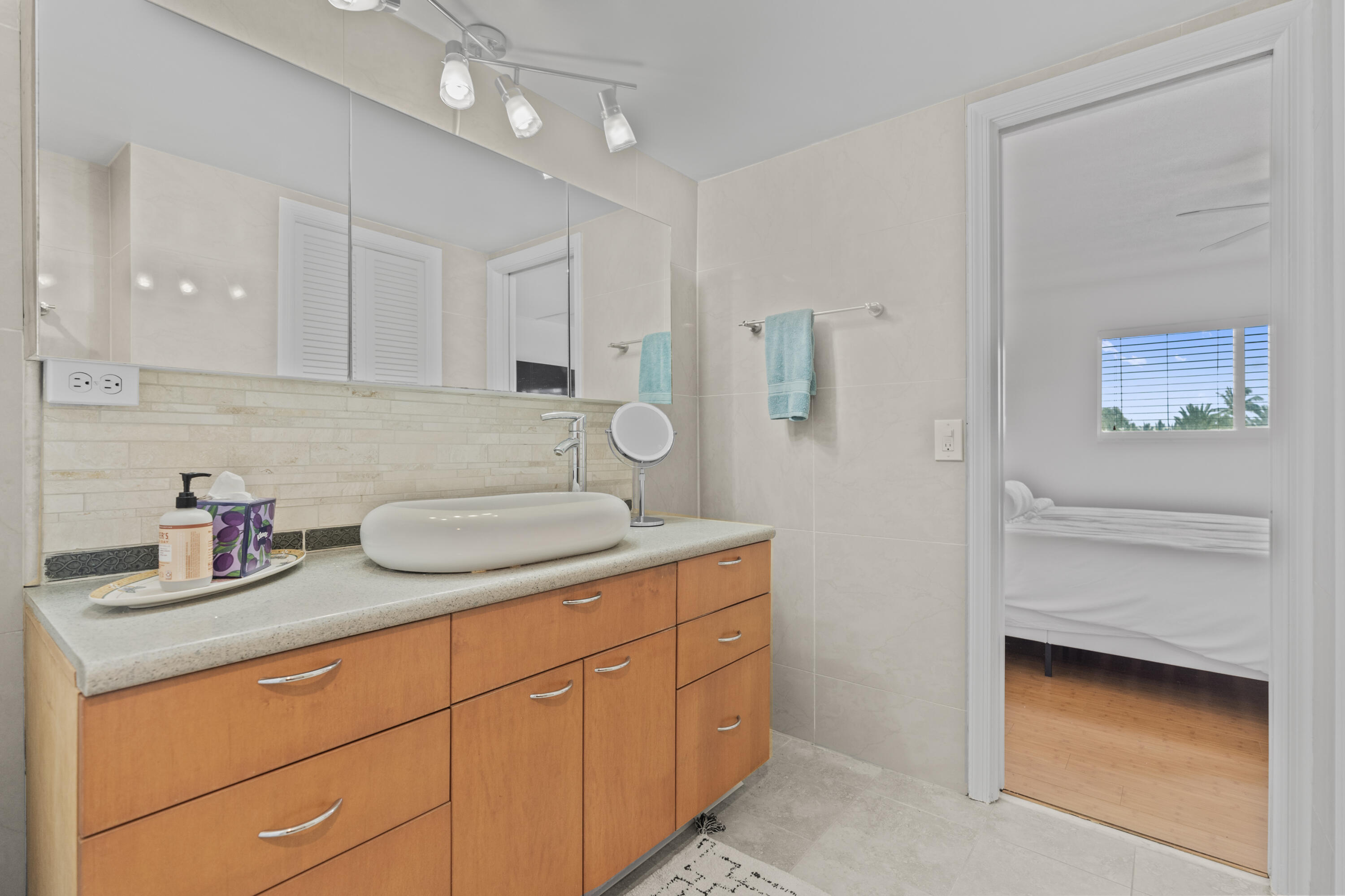 750 Northeast Spanish River Boulevard, Unit 2040 Boca Raton, FL 33431 - Photo 14 of 40 a bathroom with a granite countertop sink and a mirror