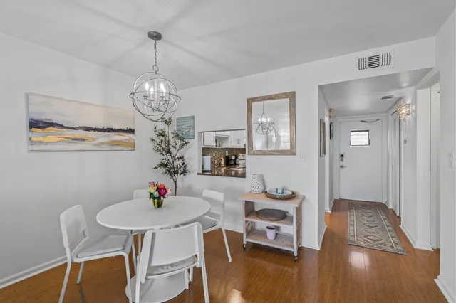 a view of a dining room with furniture wooden floor and chandelier