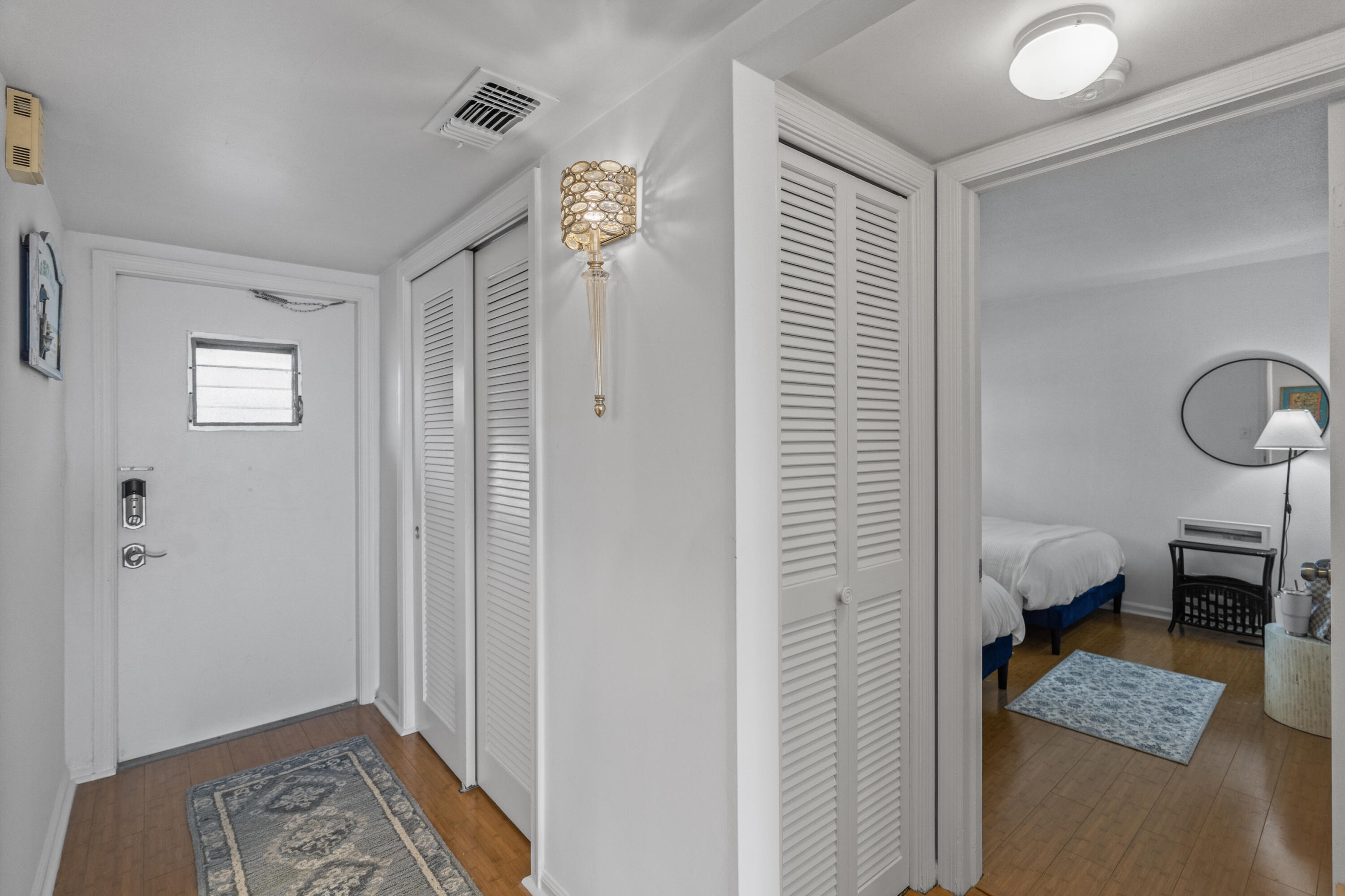 750 Northeast Spanish River Boulevard, Unit 2040 Boca Raton, FL 33431 - Photo 18 of 40 a bedroom with a bed and a window