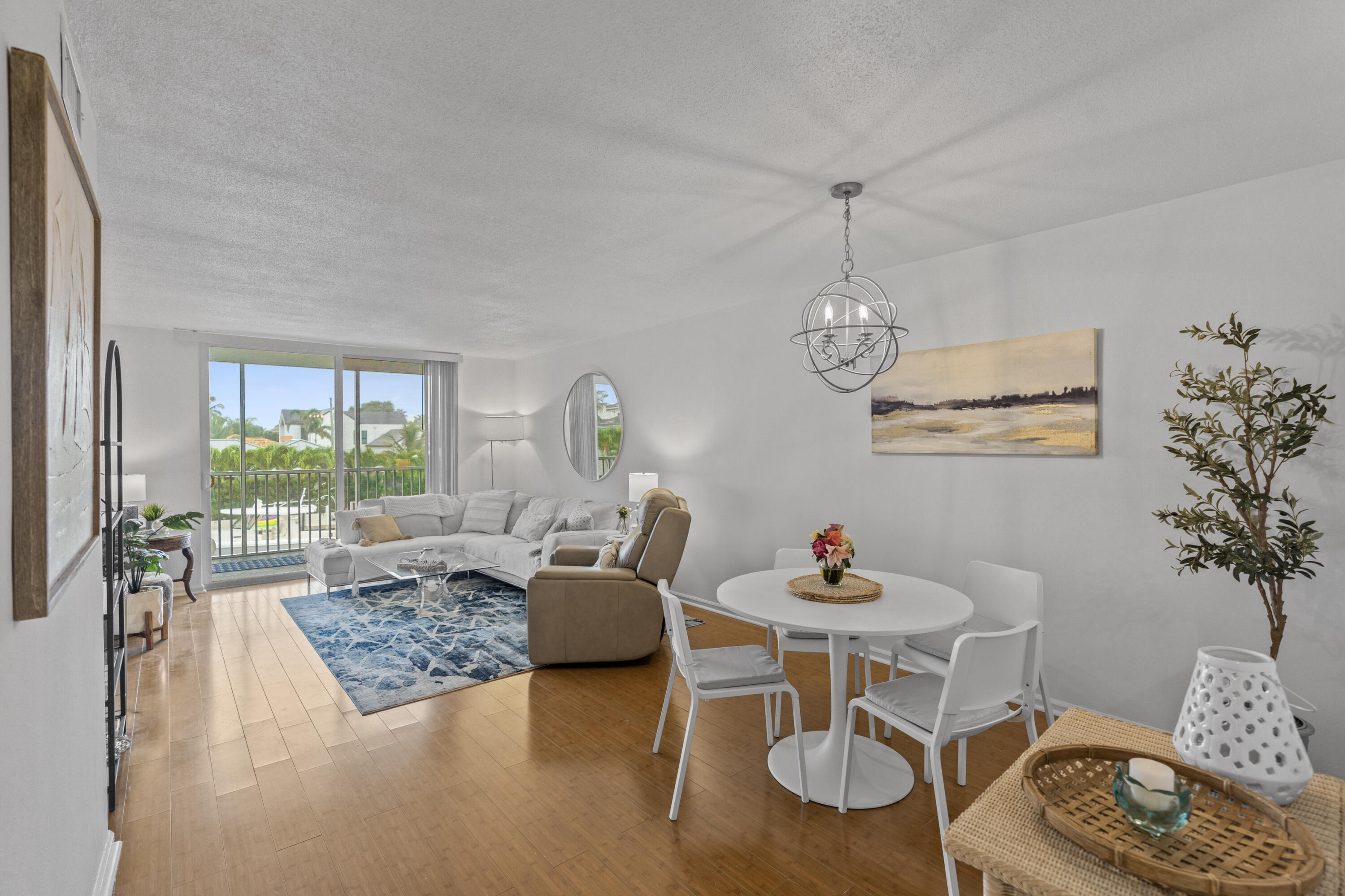 750 Northeast Spanish River Boulevard, Unit 2040 Boca Raton, FL 33431 - Photo 2 of 40 a living room with furniture and a chandelier