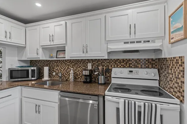 a kitchen with refrigerator cabinets and ceiling fan