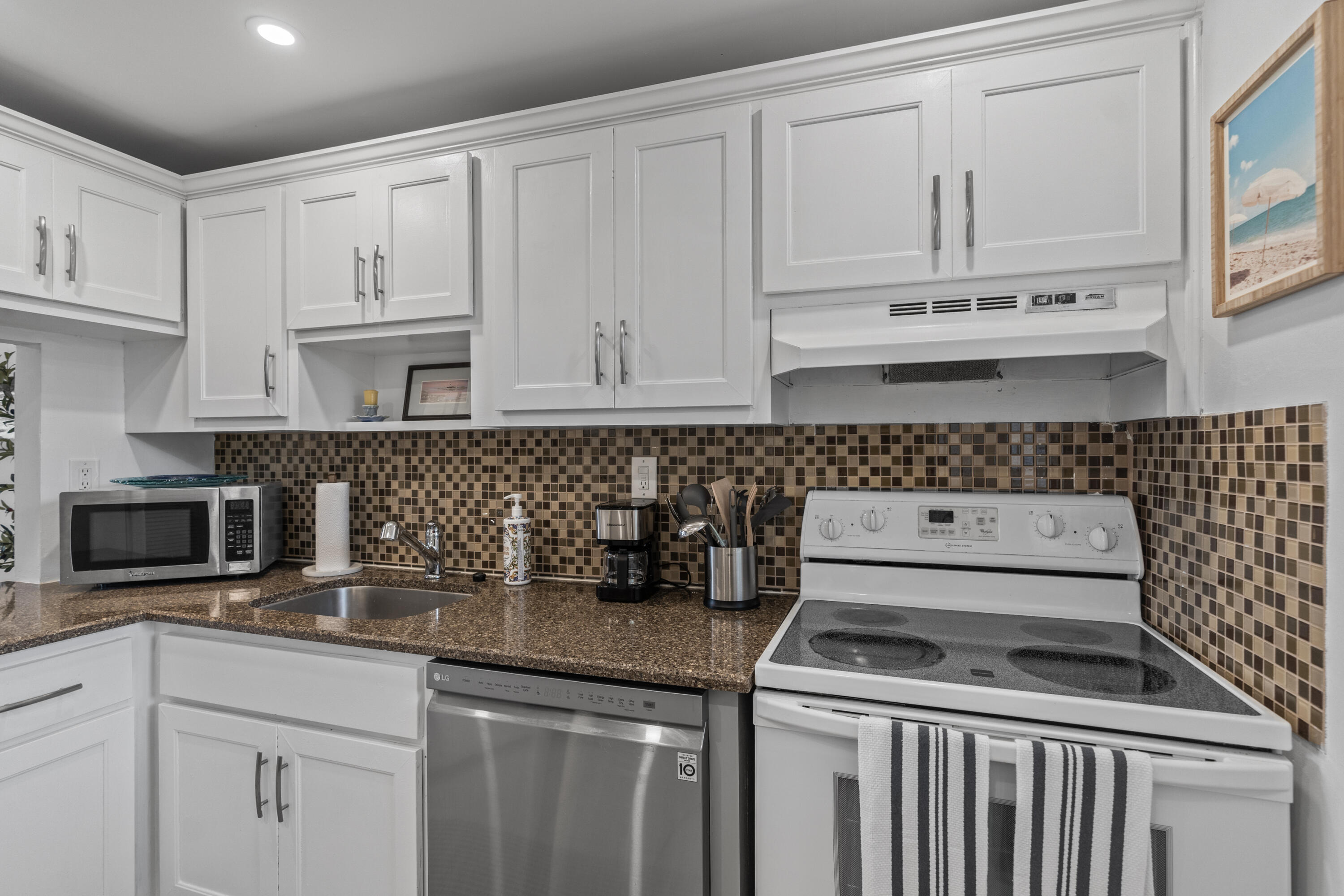 750 Northeast Spanish River Boulevard, Unit 2040 Boca Raton, FL 33431 - Photo 21 of 40 a kitchen with appliances a sink and cabinets