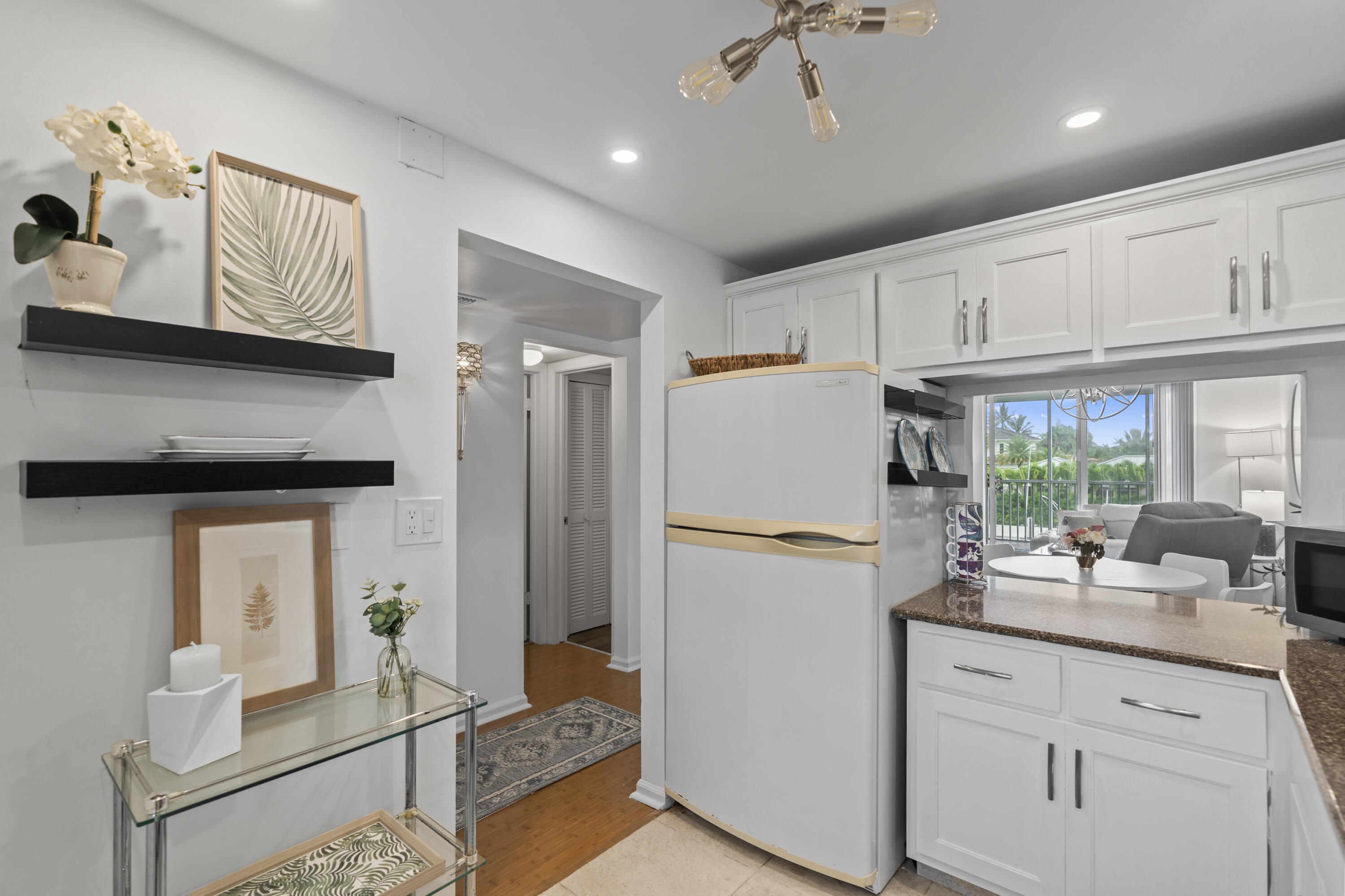 750 Northeast Spanish River Boulevard, Unit 2040 Boca Raton, FL 33431 - Photo 22 of 40 a kitchen with refrigerator cabinets and ceiling fan