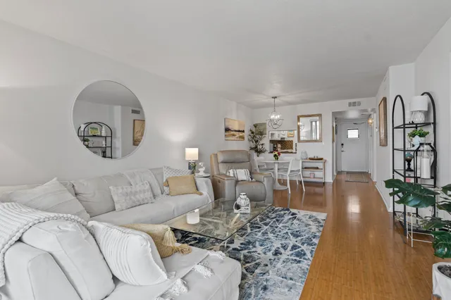 a living room with furniture a rug and a window