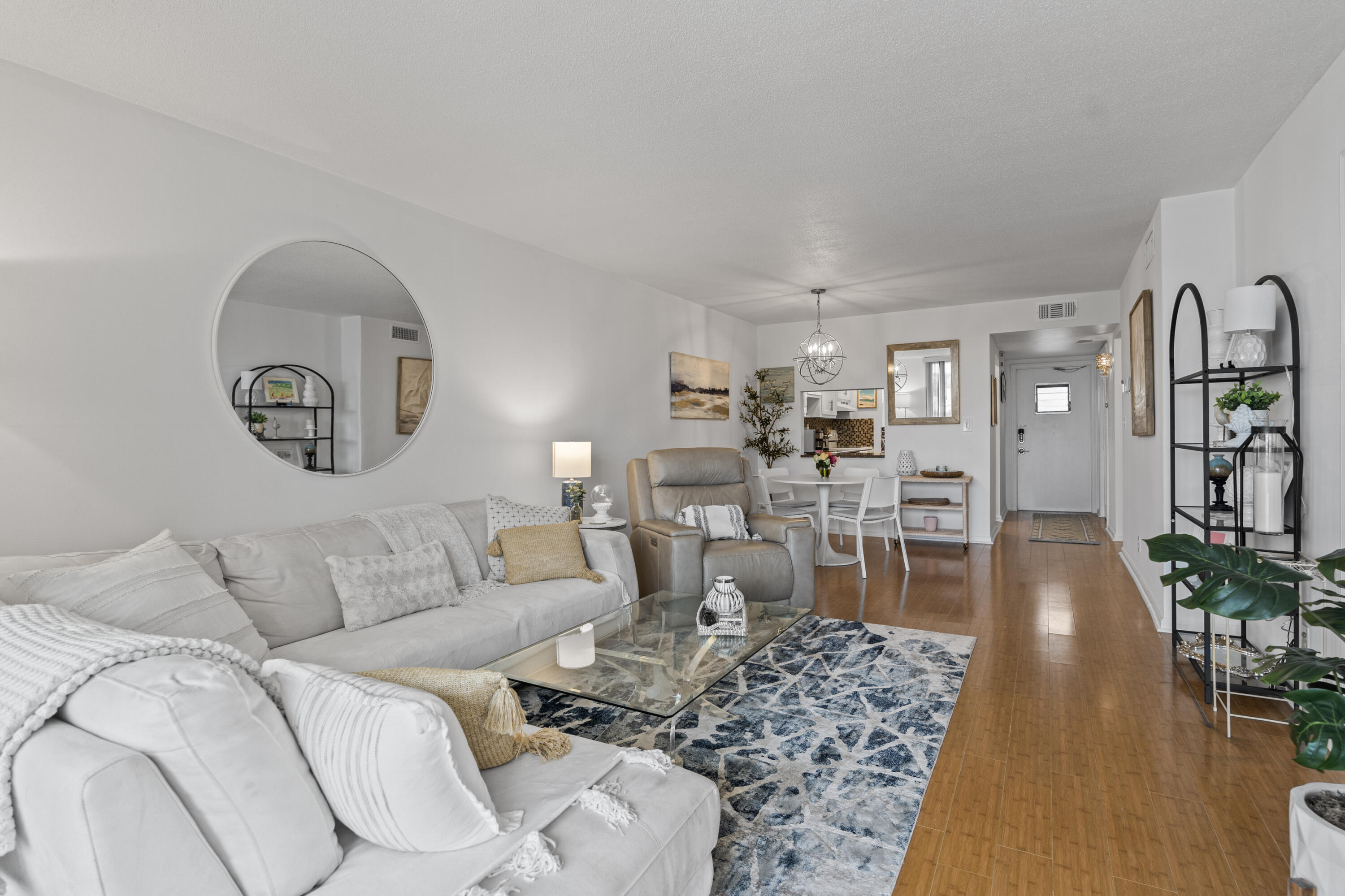 750 Northeast Spanish River Boulevard, Unit 2040 Boca Raton, FL 33431 - Photo 24 of 40 a living room with furniture and a large mirror with wooden floor