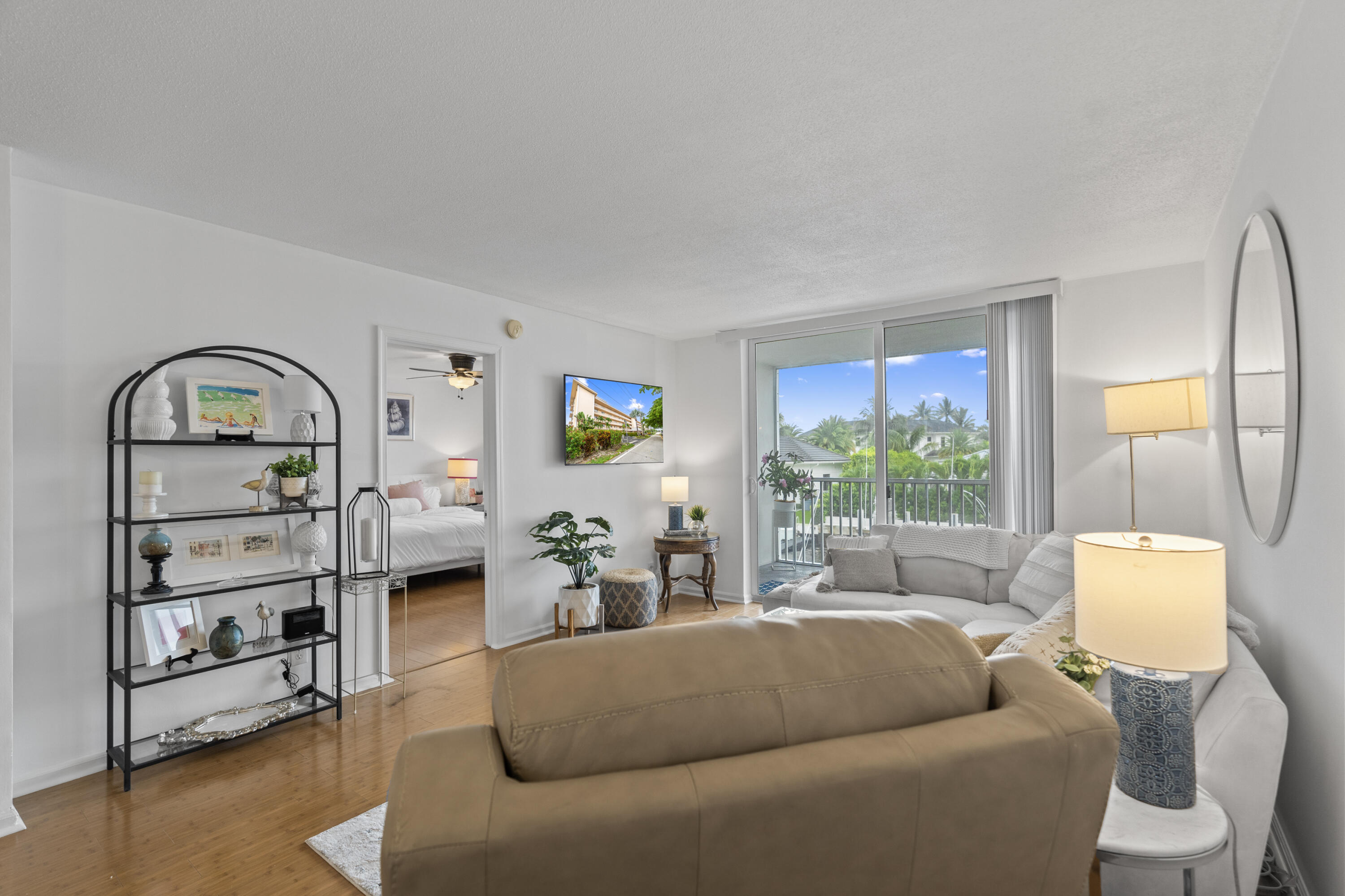 750 Northeast Spanish River Boulevard, Unit 2040 Boca Raton, FL 33431 - Photo 25 of 40 a living room with furniture a rug and a window