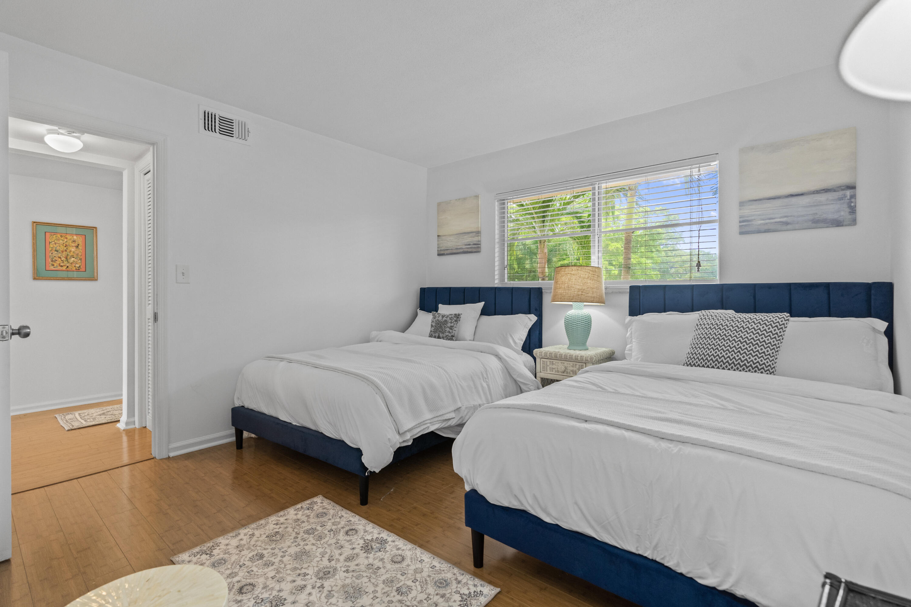 750 Northeast Spanish River Boulevard, Unit 2040 Boca Raton, FL 33431 - Photo 4 of 40 a bedroom with two beds and a dresser next to a window