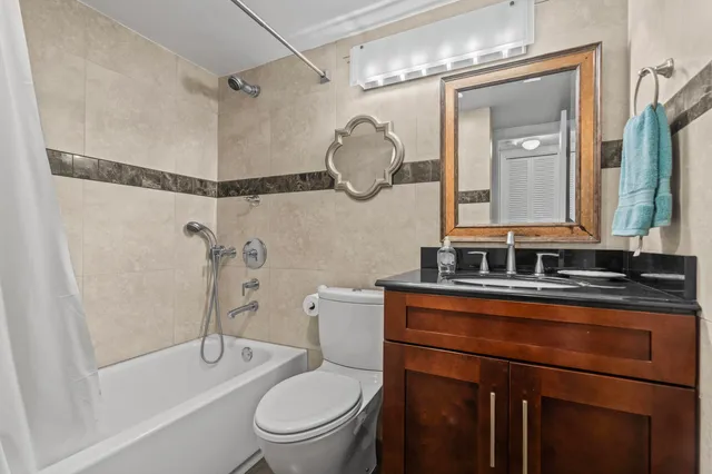 a bathroom with a toilet a sink and a mirror