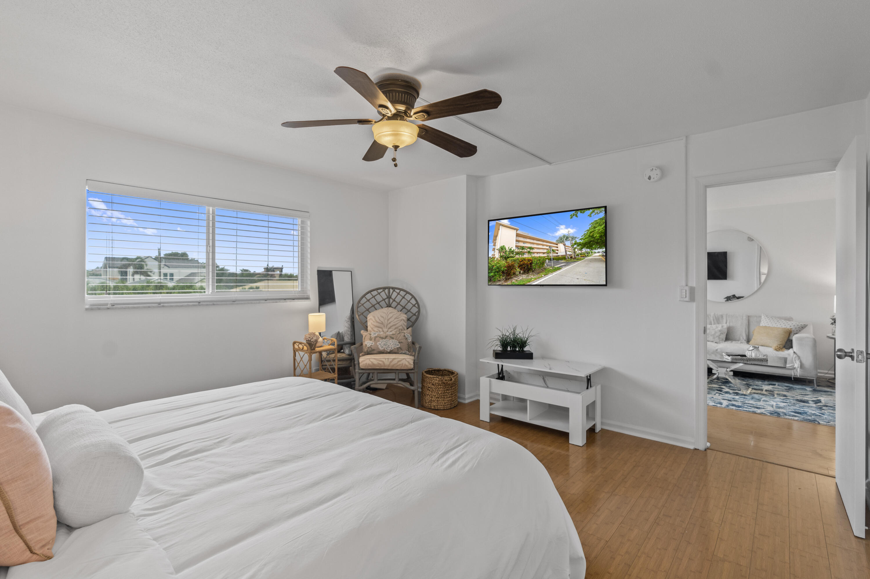 750 Northeast Spanish River Boulevard, Unit 2040 Boca Raton, FL 33431 - Photo 8 of 40 a bedroom with a bed and a chandelier