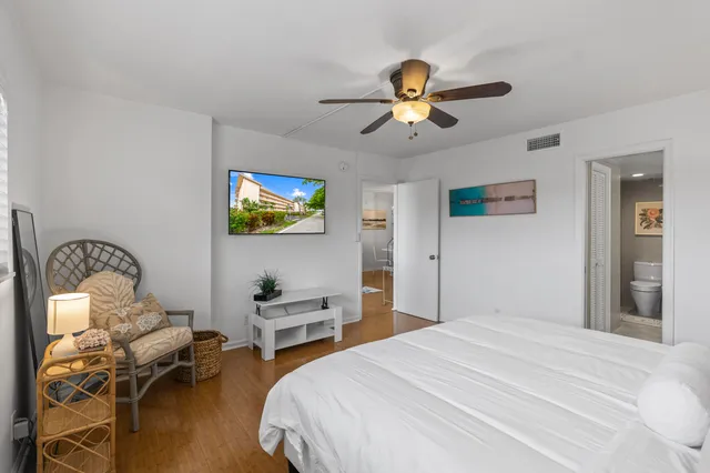 a bedroom with bed and a chandelier