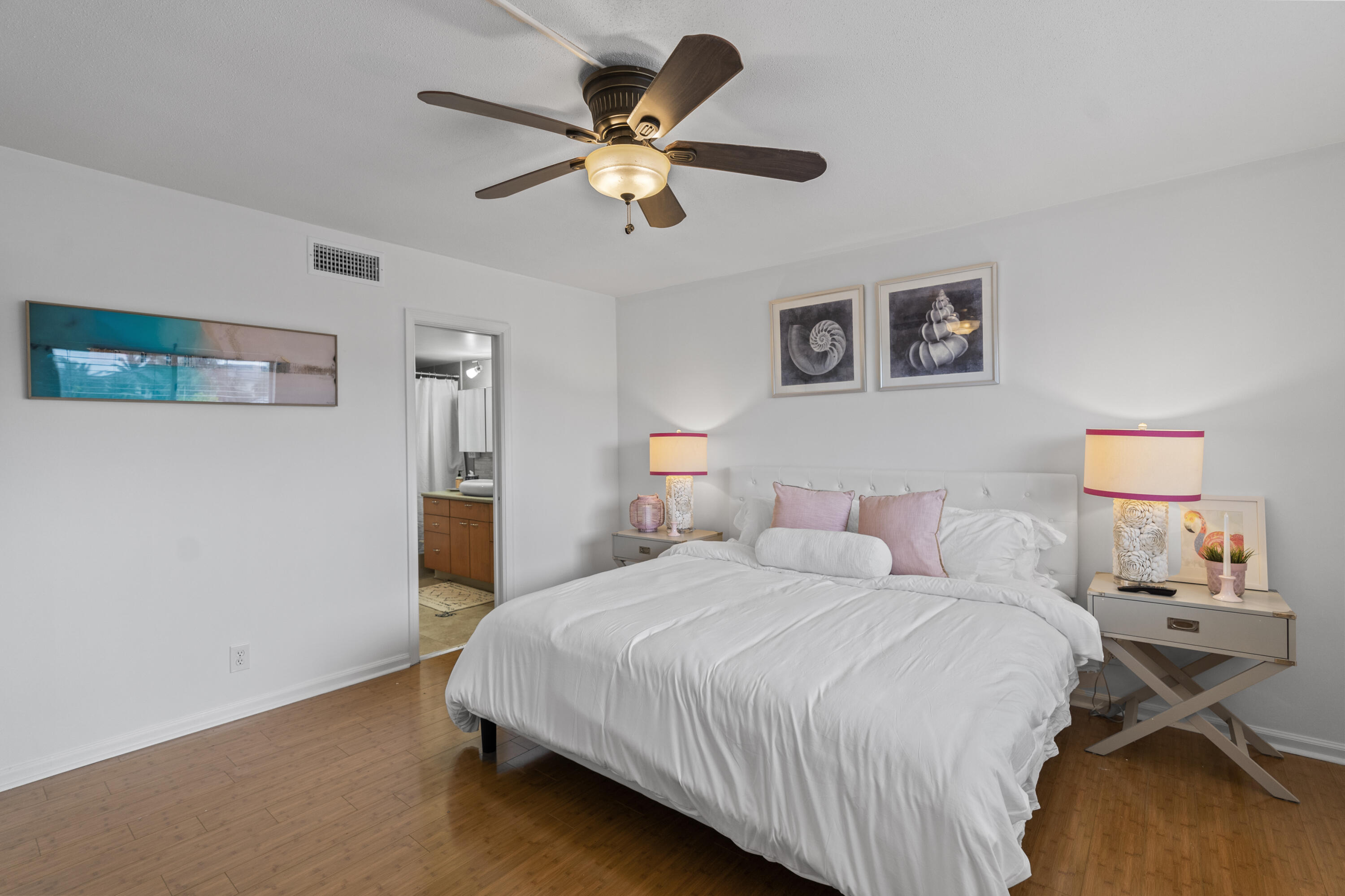 750 Northeast Spanish River Boulevard, Unit 2040 Boca Raton, FL 33431 - Photo 10 of 40 a bedroom with a bed and a chandelier