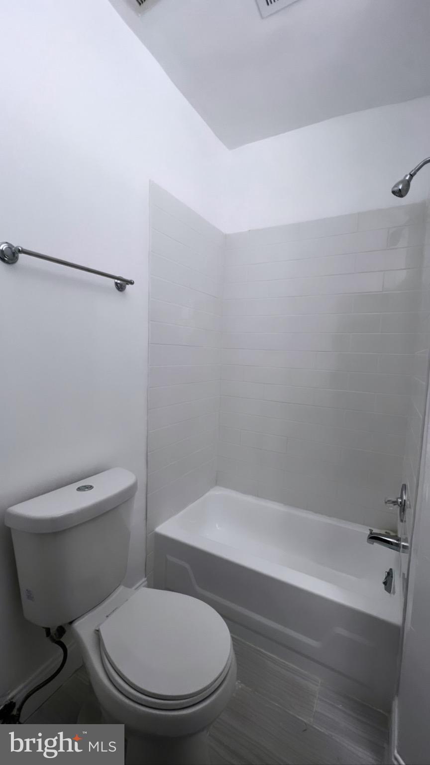 1345 1st Street Northwest, Unit 2 Washington, DC 20001 - Photo 17 of 19 a white toilet sitting next to a bath tub