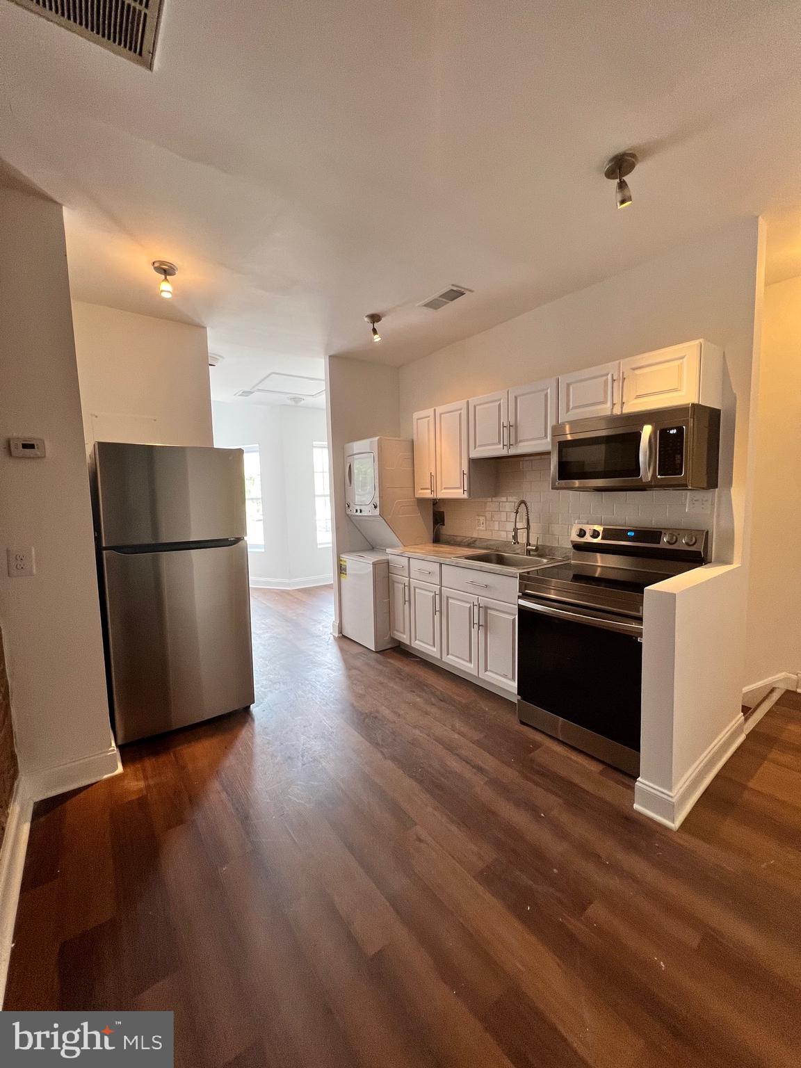 1345 1st Street Northwest, Unit 2 Washington, DC 20001 - Photo 3 of 19 a kitchen with stainless steel appliances a refrigerator and a stove top oven