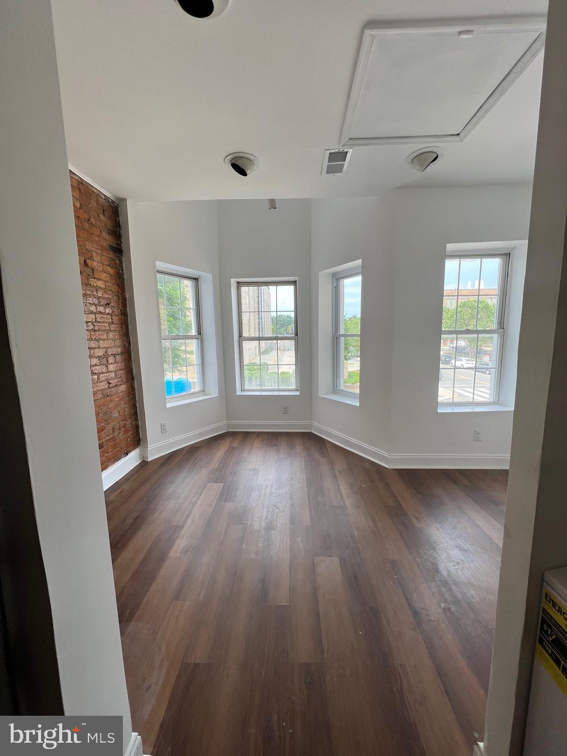 1345 1st Street Northwest, Unit 2 Washington, DC 20001 - Photo 5 of 19 wooden floor in an empty room with a window