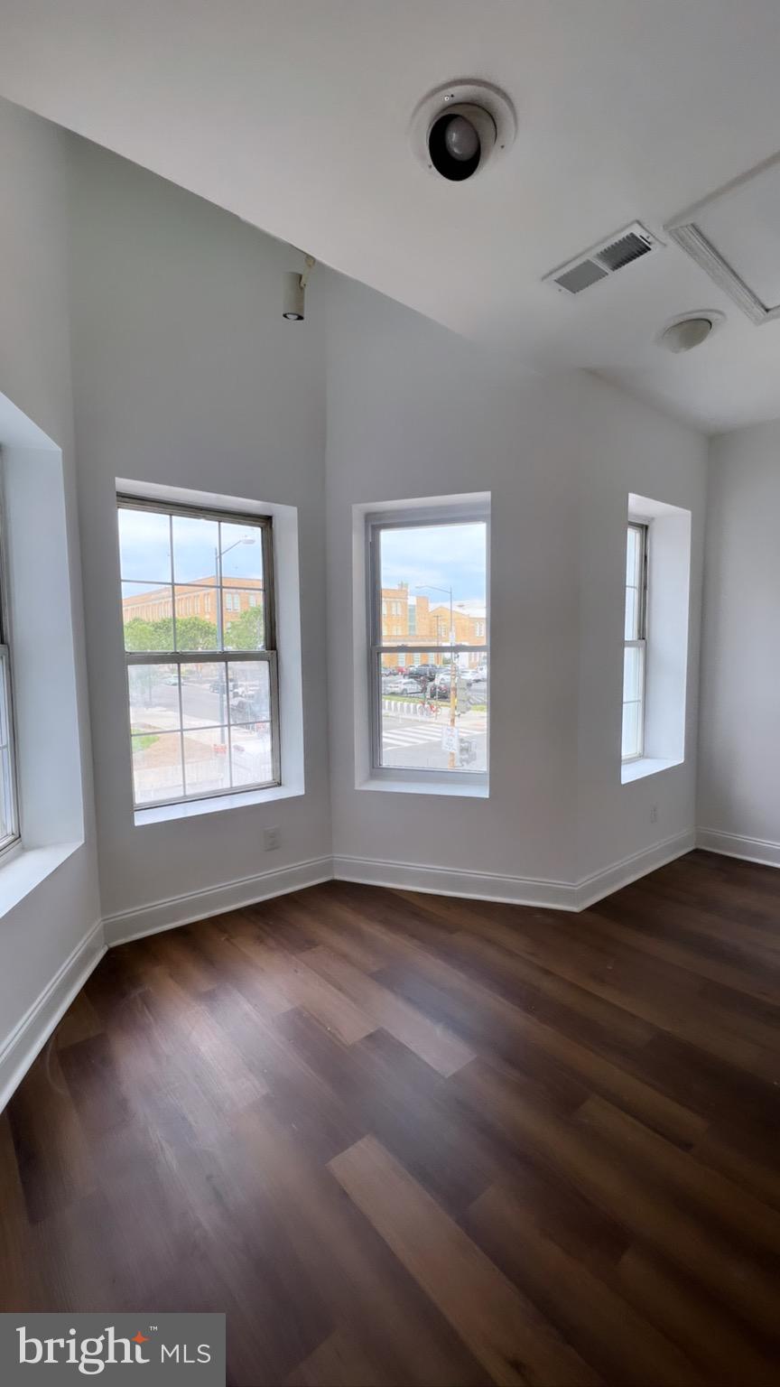 1345 1st Street Northwest, Unit 2 Washington, DC 20001 - Photo 8 of 19 a view of an empty room with wooden floor and a window